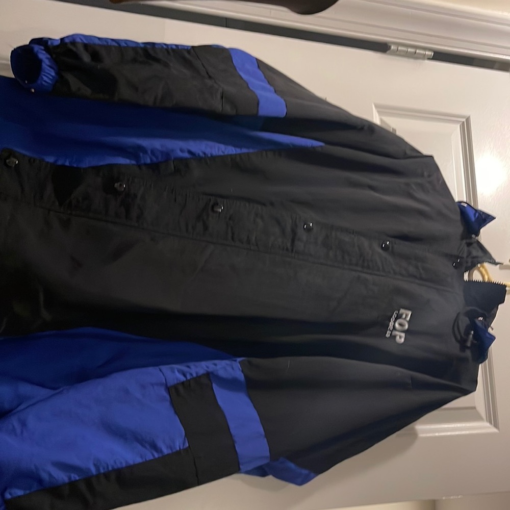 Used rain jacket, black and blue drawstring